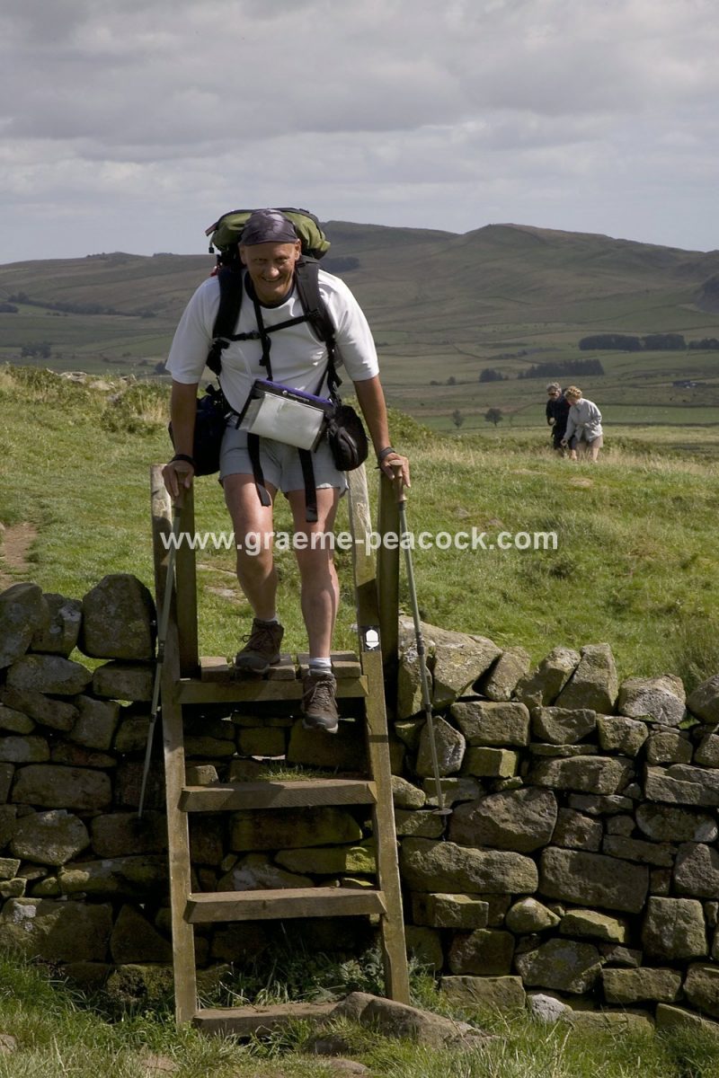 Walkers approaching Hadrian's Wall at Cawfields, near Haltwhistle