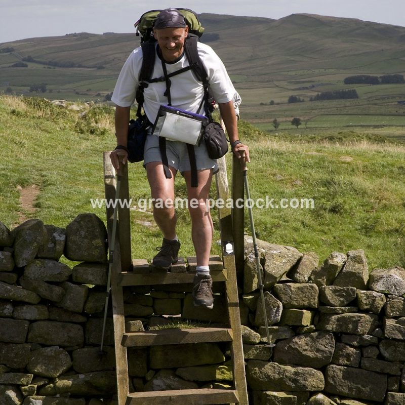 Walkers approaching Hadrian's Wall at Cawfields, near Haltwhistle
