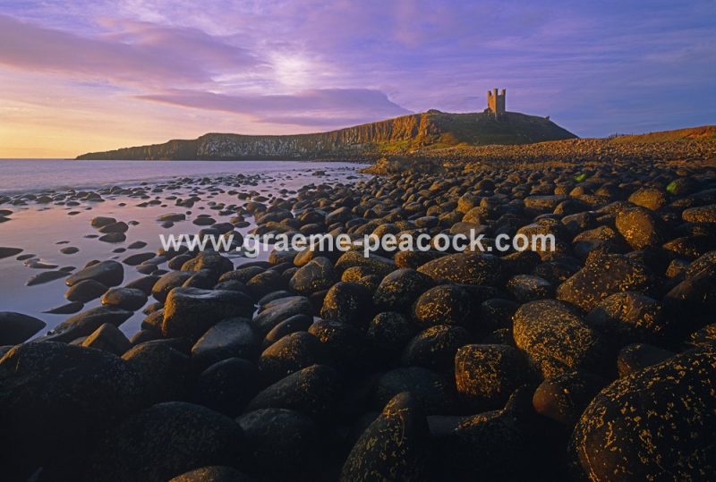 Summer solstice dawn at Dunstanburgh Castle near Embleton, Northumberland