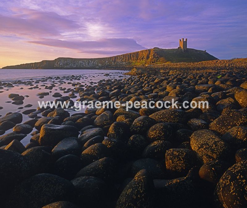 Summer solstice dawn at Dunstanburgh Castle near Embleton, Northumberland