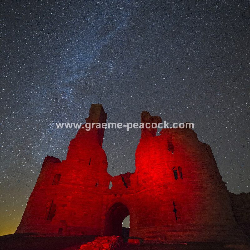 Star gazing under 'Dark Skies' at Dunstanburgh Castle near Craster, Northumberland