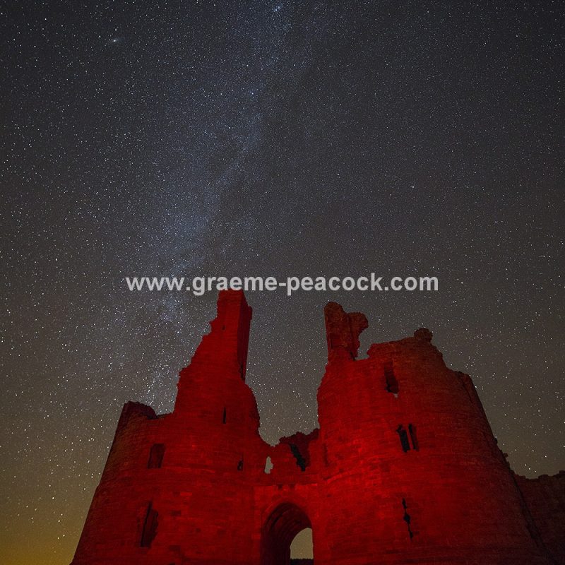 Star gazing under 'Dark Skies' at Dunstanburgh Castle near Craster, Northumberland