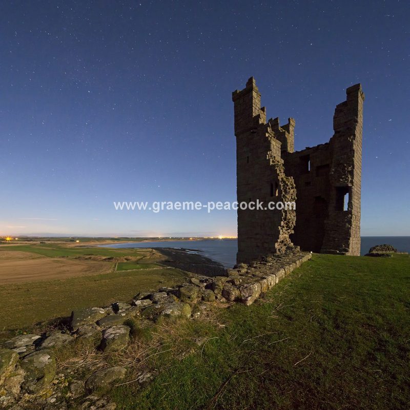 Star gazing under 'Dark Skies' at Dunstanburgh Castle near Craster, Northumberland