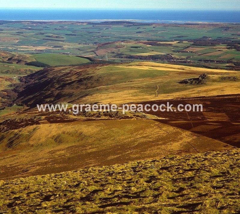Bamburgh Castle and Lindisfarne from Hedgehope Hill near Wooler, Cheviot Hills, Northumberland, NNPA