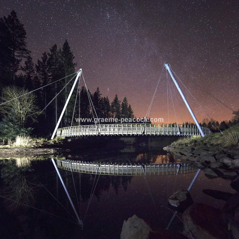 Star gazing under 'Dark Skies' at Lewisburn bridge at Kielder Water near Falstone, Northumberland