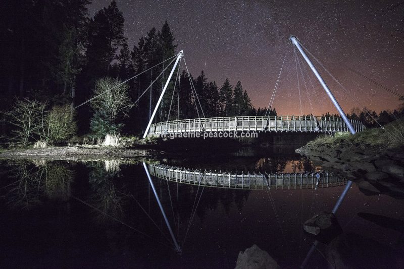 Star gazing under 'Dark Skies' at Lewisburn bridge at Kielder Water near Falstone, Northumberland