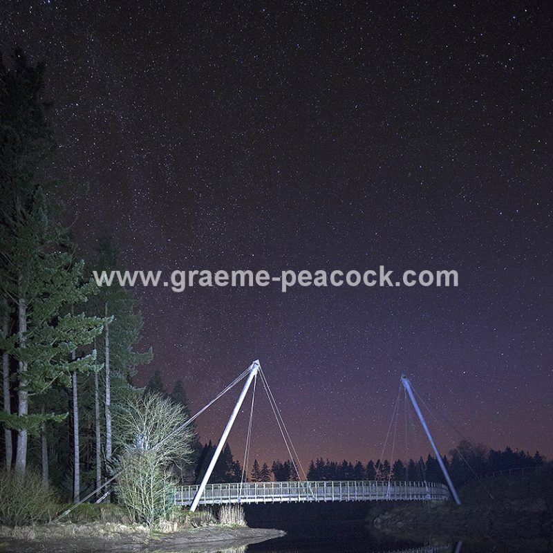 Star gazing under 'Dark Skies' at Lewisburn bridge at Kielder Water near Falstone, Northumberland