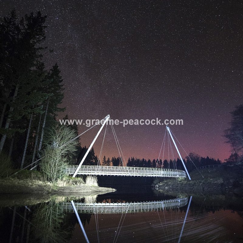 Star gazing under 'Dark Skies' at Lewisburn bridge at Kielder Water near Falstone, Northumberland