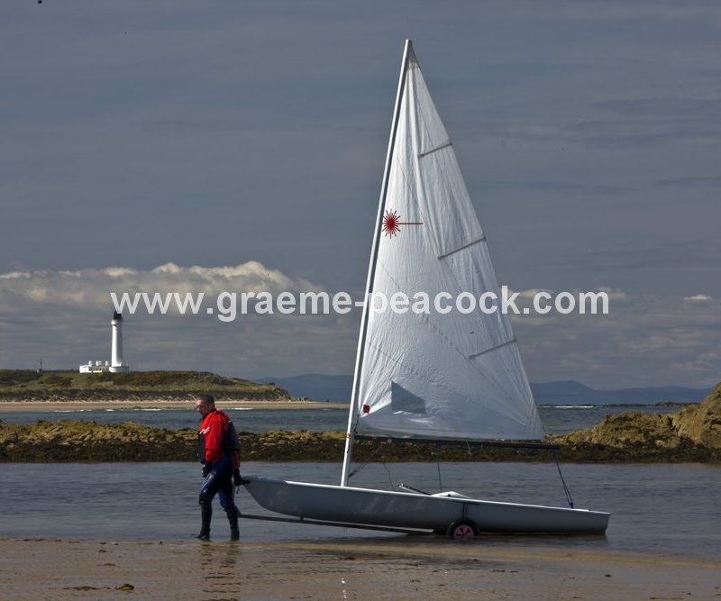 Yacht at Covesea lighthouse,  Lossiemouth,  Moray,  Scotland
