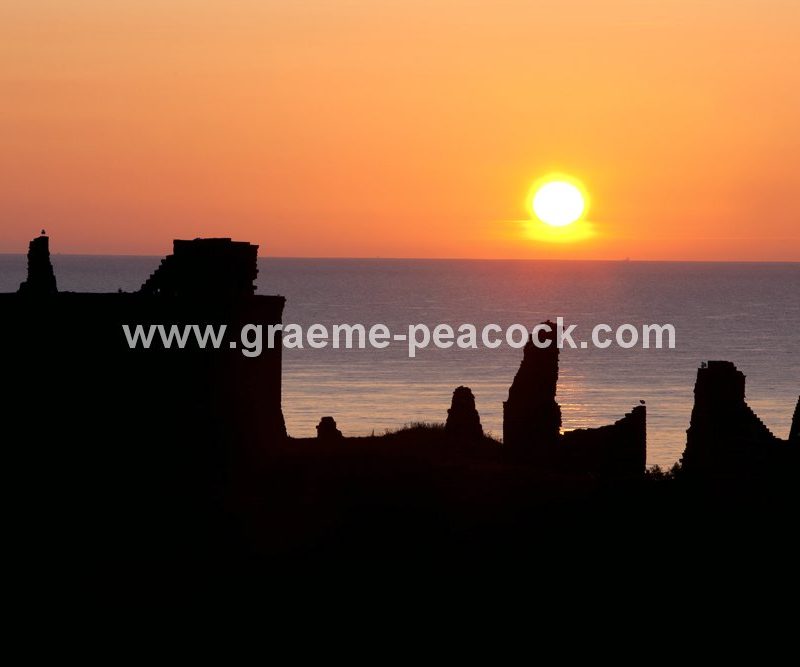 Burnished sun at Dunnottar Castle near Stonehaven, Aberdeenshire, Scotland