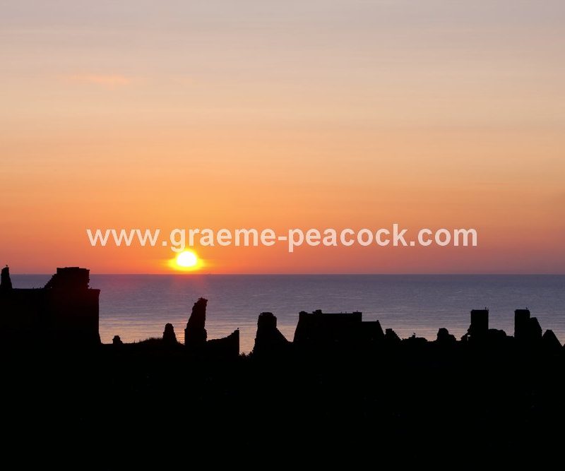 Burnished sun at Dunnottar Castle near Stonehaven, Aberdeenshire, Scotland