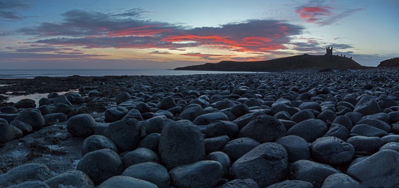 Sunrise at Dunstanburgh Castle near Embleton, Northumberland, England, United Kingdom