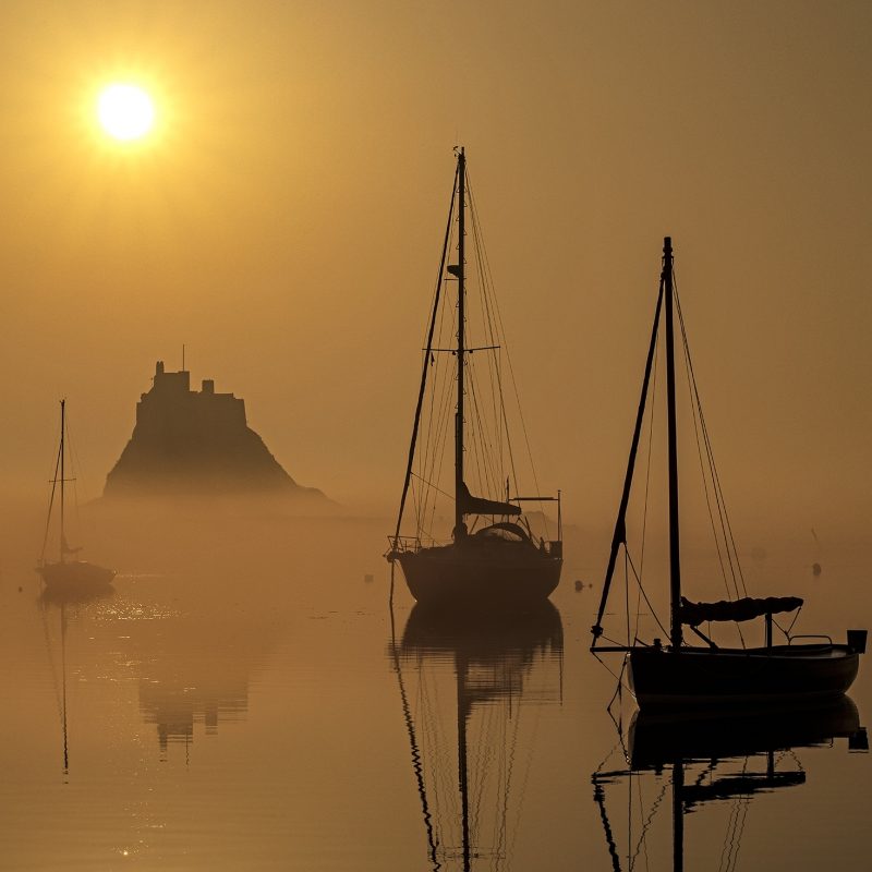 Sunrise over Lindisfarne Castle on the Holy Island of Lindisfarne, Northumberland, England, United Kingdom