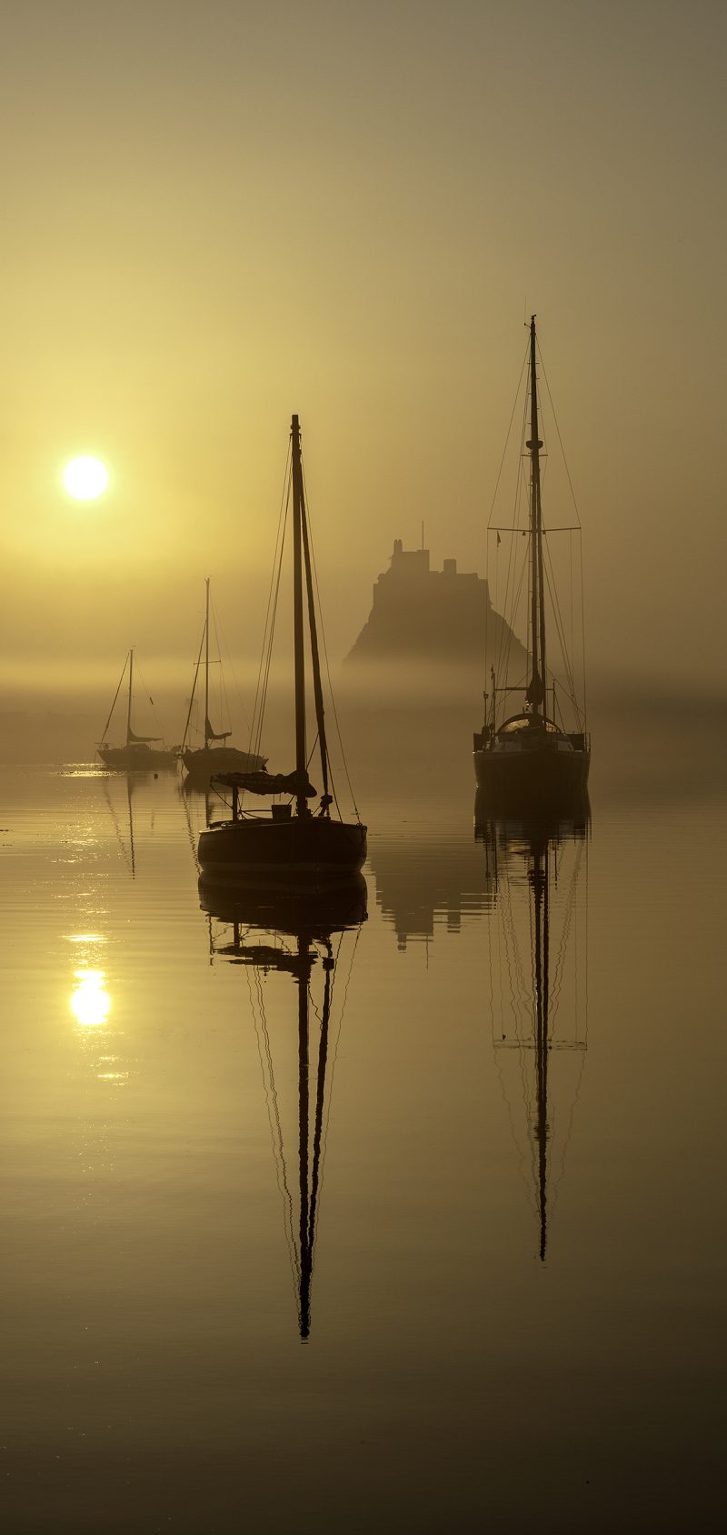 Sunrise over Lindisfarne Castle on the Holy Island of Lindisfarne, Northumberland, England, United Kingdom