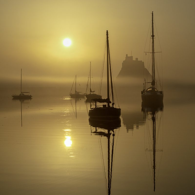 Sunrise over Lindisfarne Castle on the Holy Island of Lindisfarne, Northumberland, England, United Kingdom