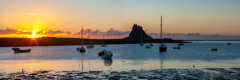 Sunrise panorama over Lindisfarne Castle, the Holy Island of Lindisfarne, Northumberland, England, United Kingdom