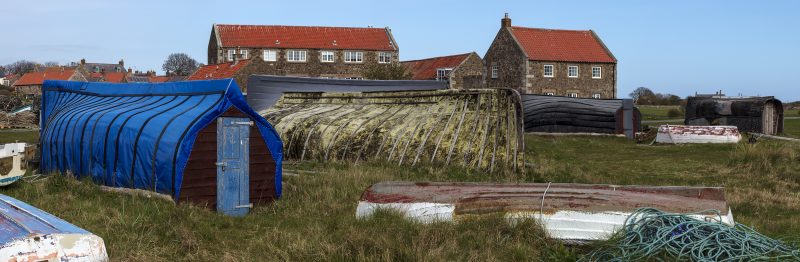 Upturned fishing boats used as huts on Lindisfarne, Northumberland, England, UK